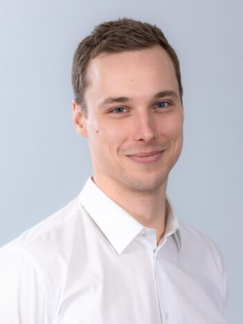 Face portrait of a man wearing a white collared shirt.