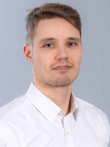 A man wearing a white collared shirt.