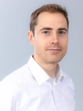 A man wearing a white collared shirt.