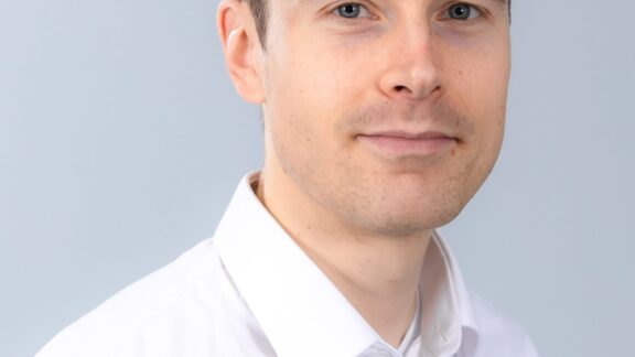 A man wearing a white collared shirt.