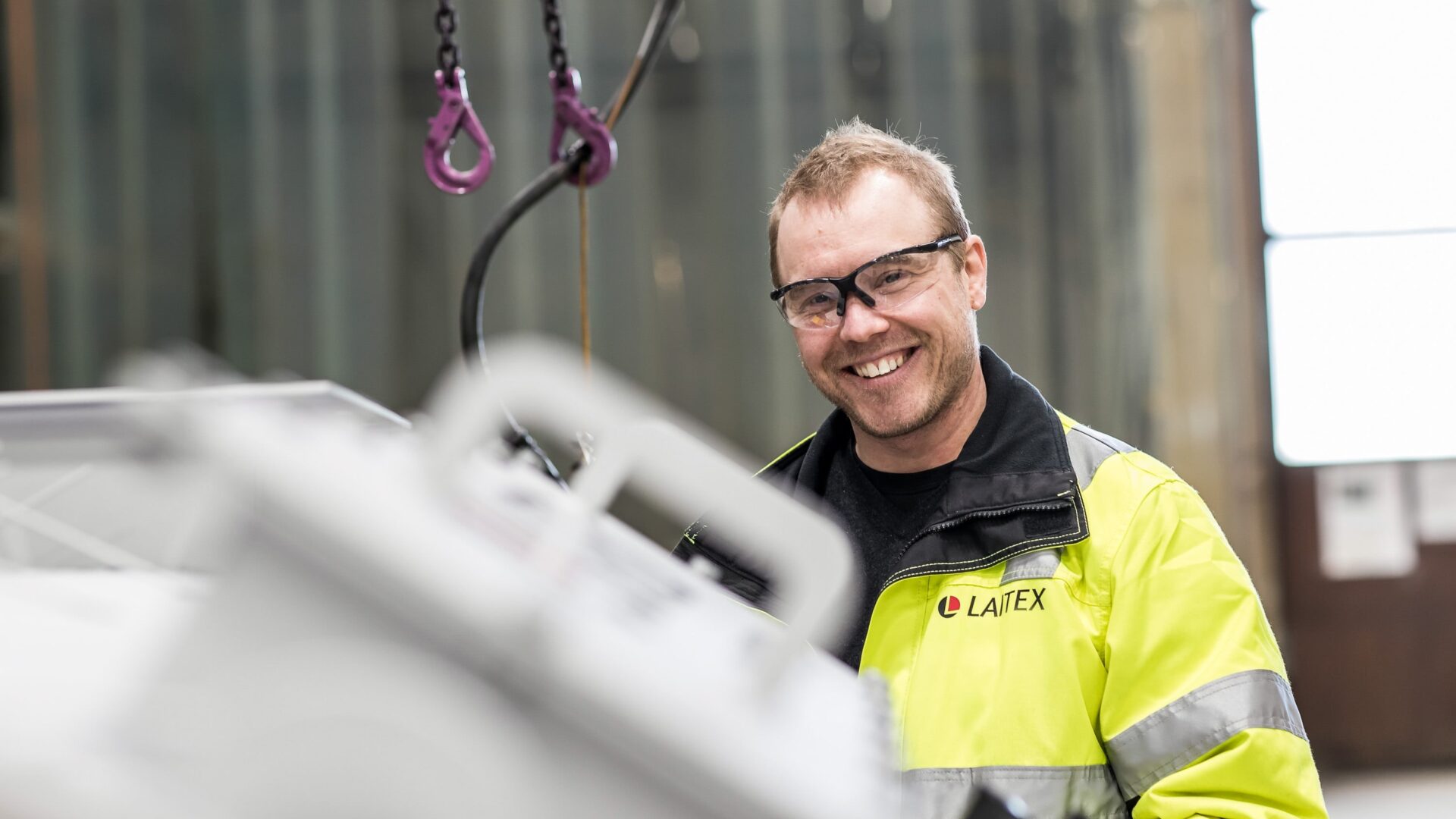 An engineer smiling and standing.