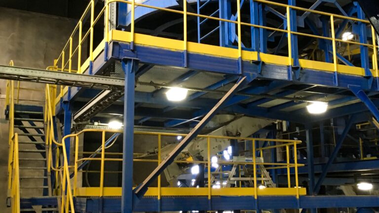 Silo chip storage and yellow security railings.