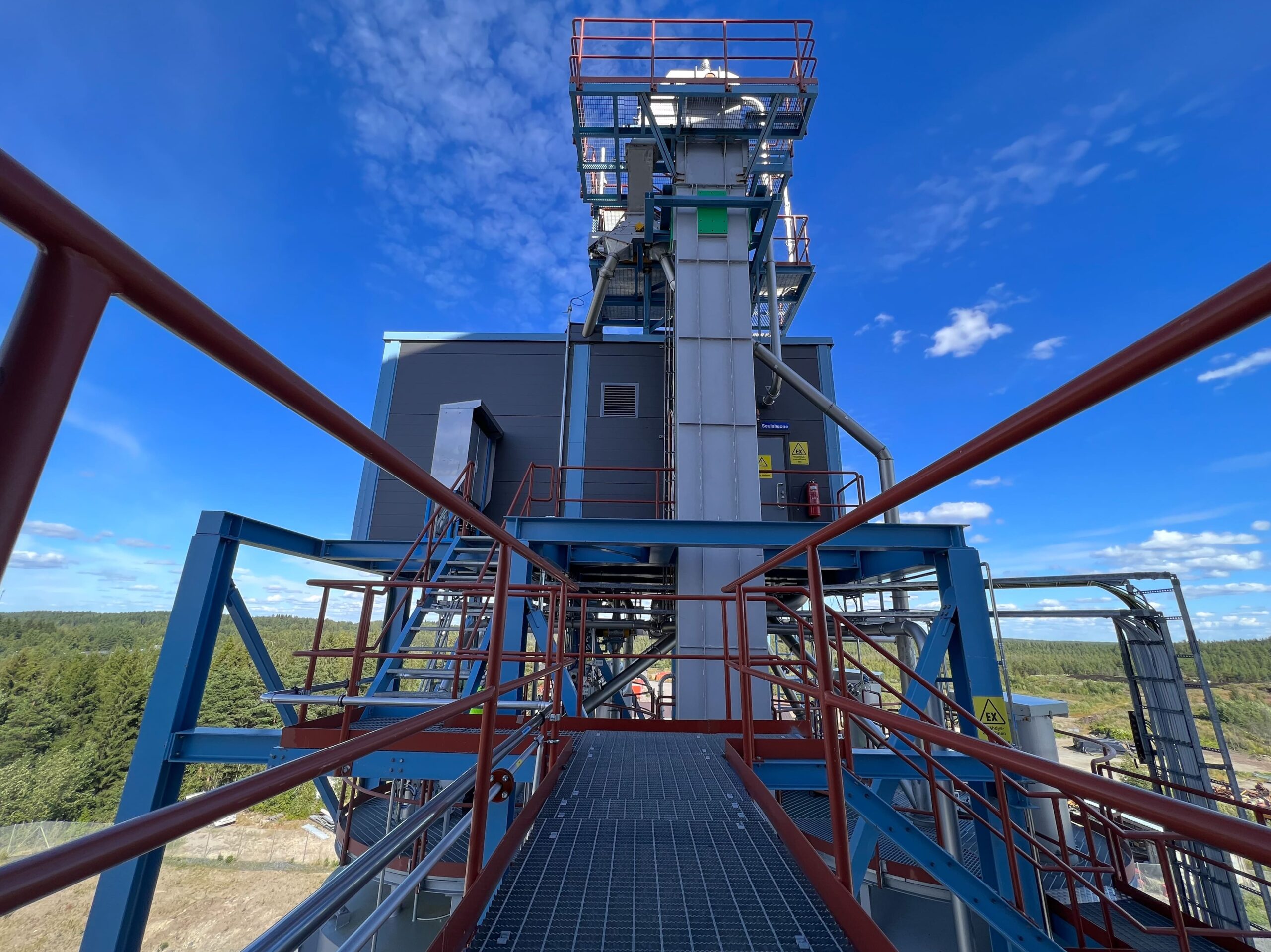 Grey bucket elevator and orange railings.
